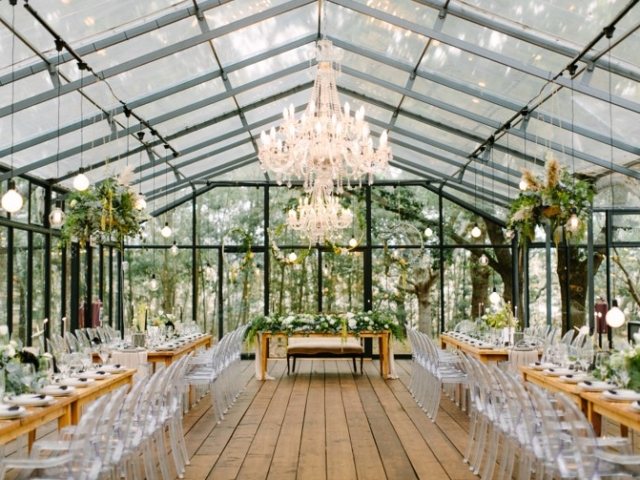 Interior view of a glasshouse with elegant decor and seating
