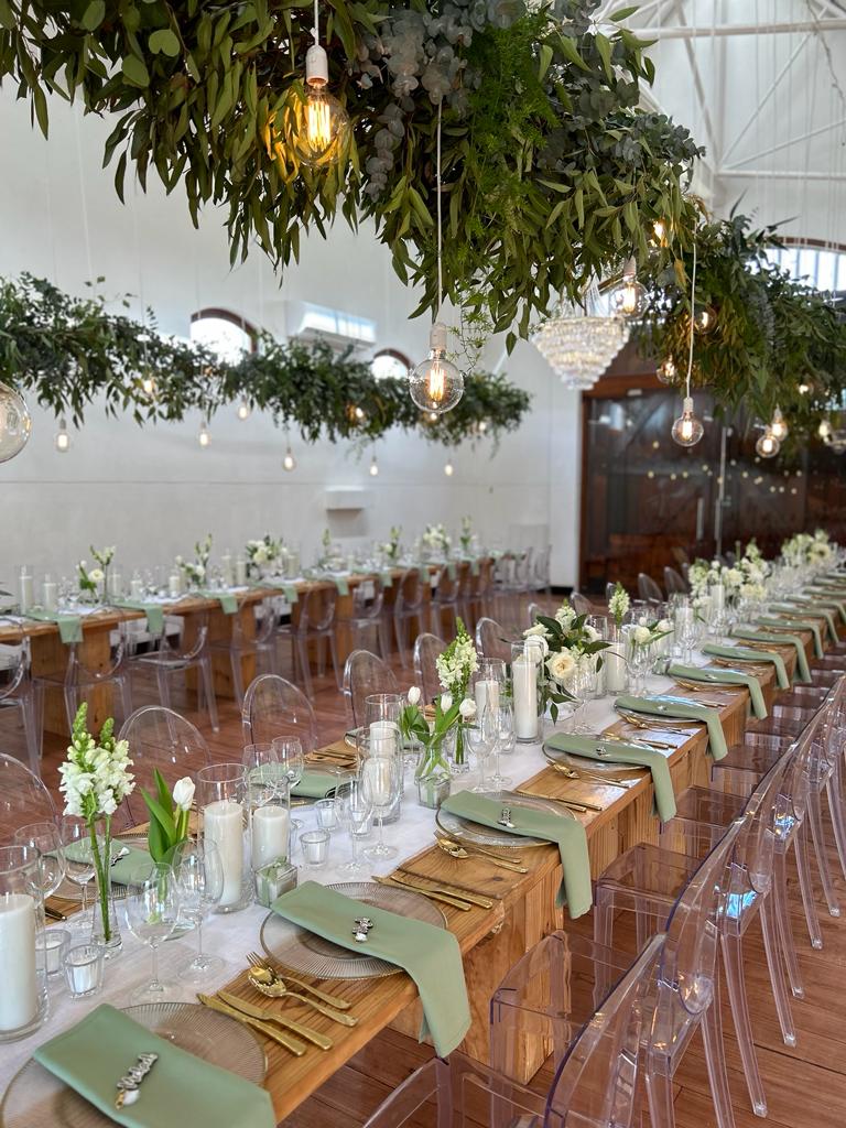 Long table beautifully set with greenery and decor