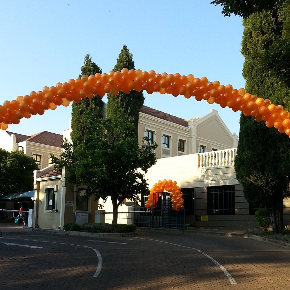 Orange balloon arch at a venue entrance