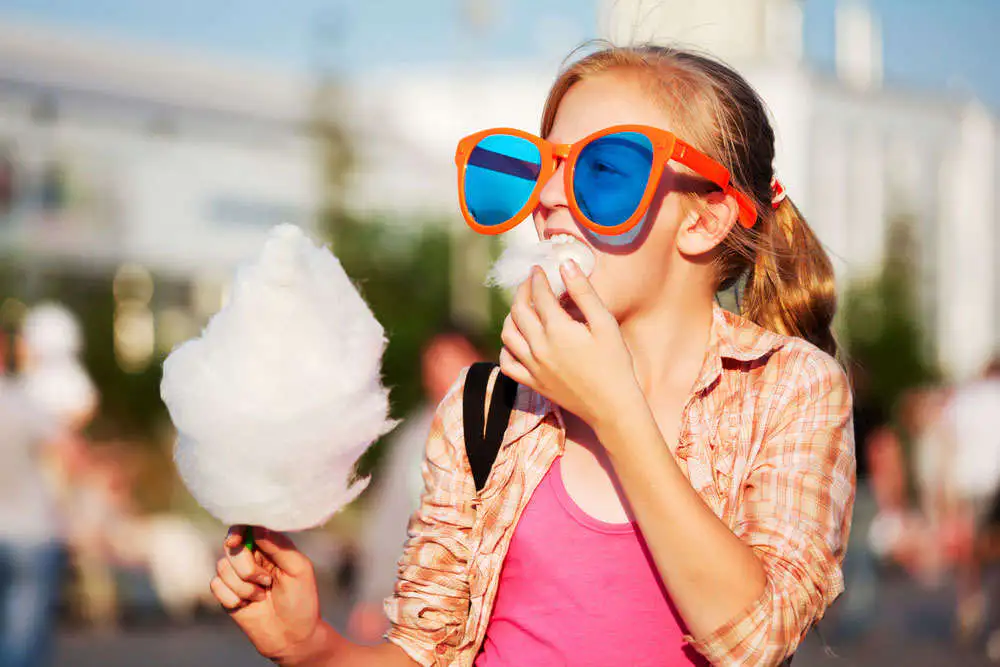 Girl with cotton candy and large sunglasses