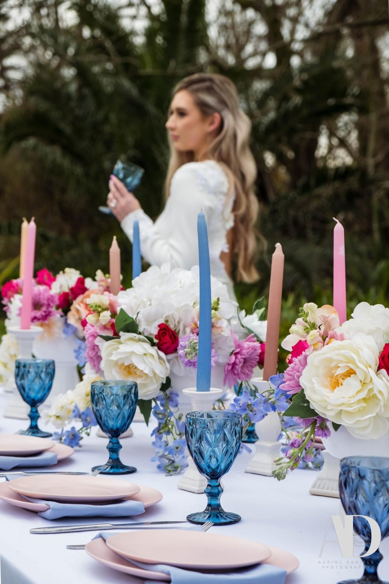 Decorative table with flowers, glassware, and candles