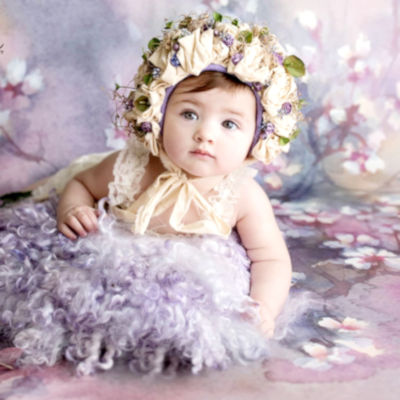 Baby in a floral bonnet and lavender outfit