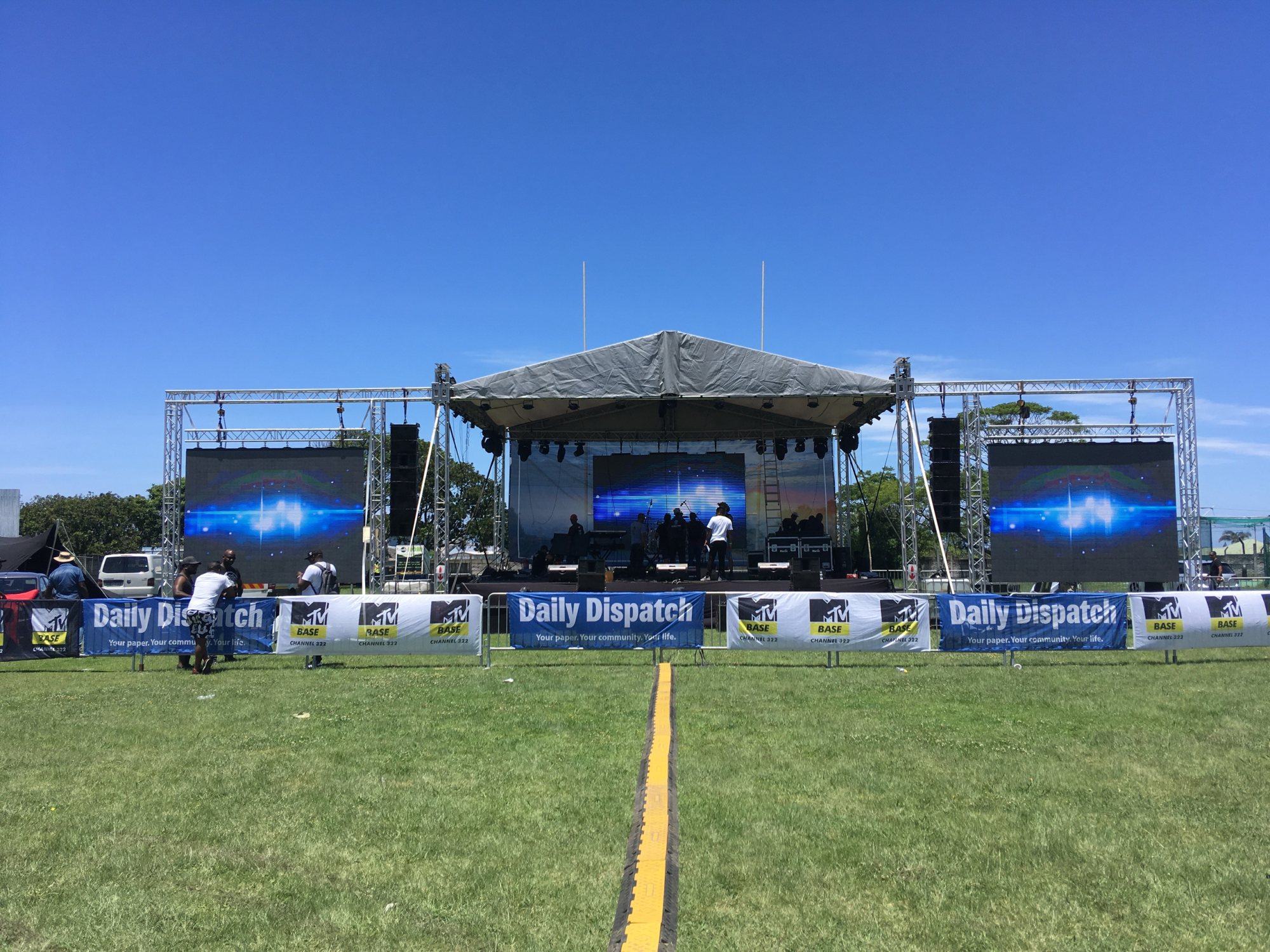 Outdoor event setup featuring LED screens and stage