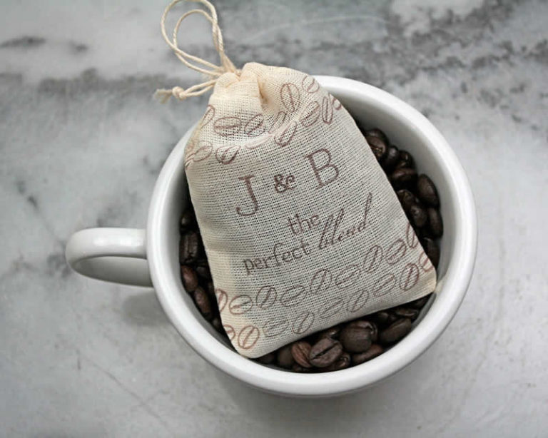 White cup with coffee beans and a blend bag