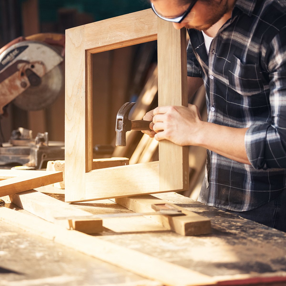 A carpenter assembling a wooden picture frame