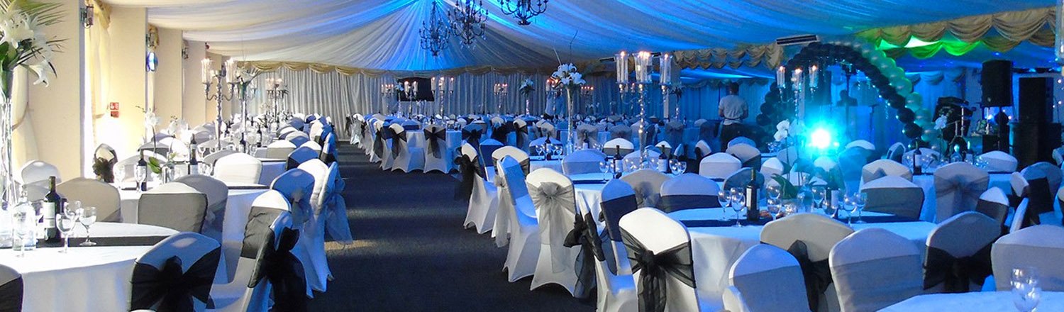 Decorated event venue with draped ceiling and table settings