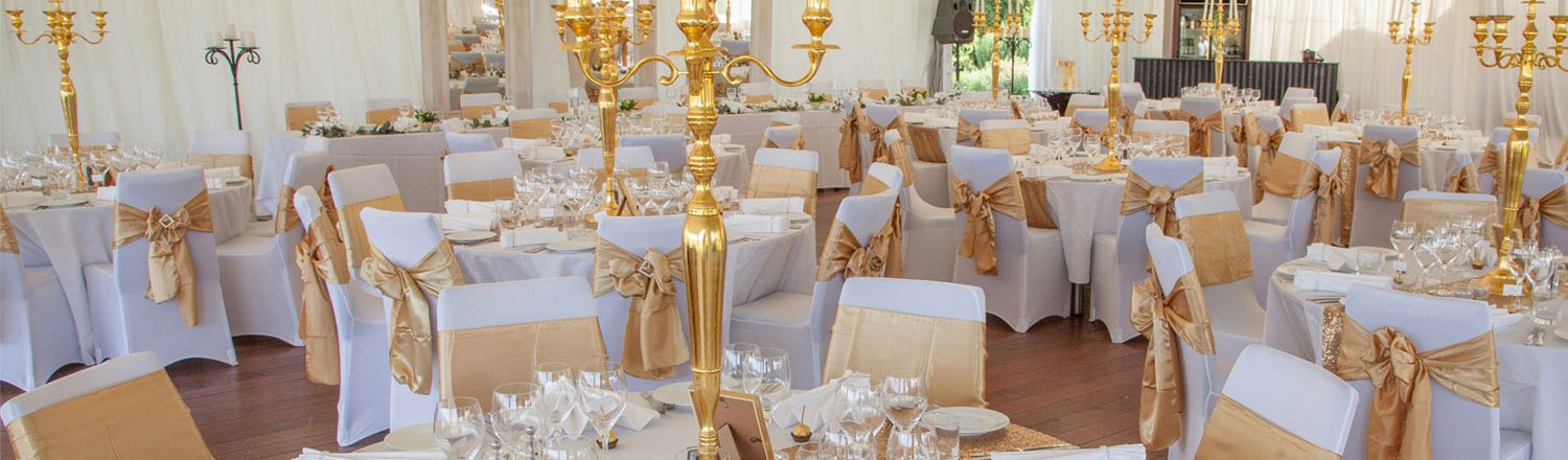 Banquet hall setup with gold and white décor