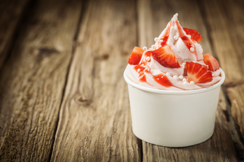 Soft serve ice cream with strawberries in a cup