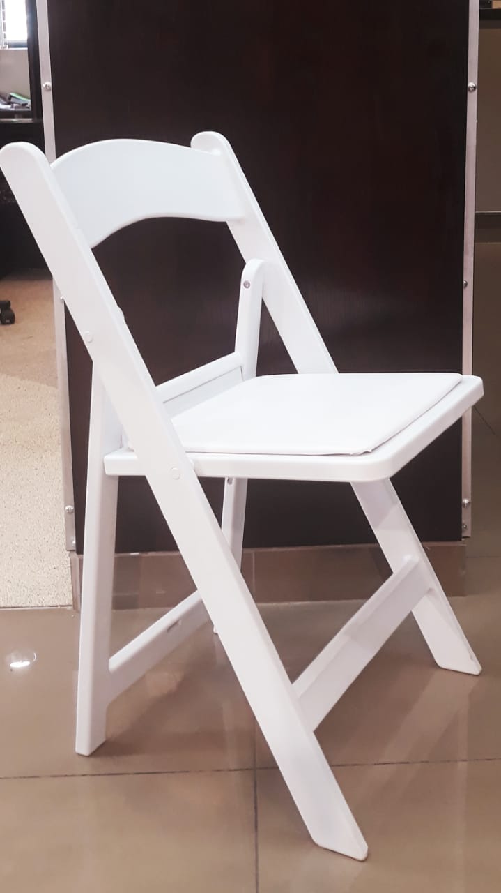 White folding chair indoors on a polished floor