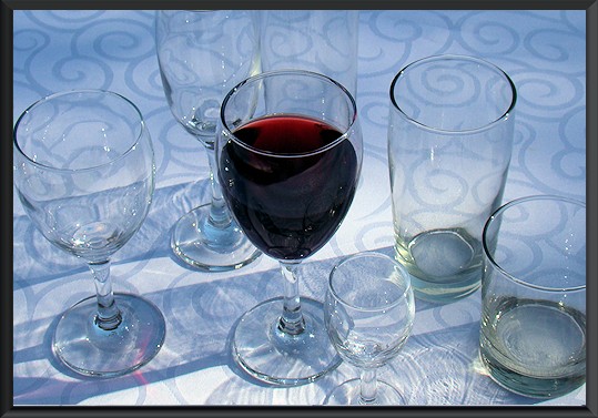 Various types of glassware including wine and water glasses.