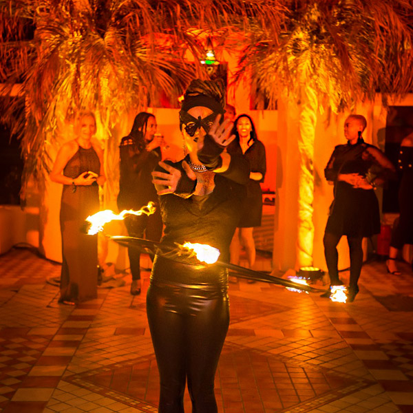 Fire dancer performing at a lively event