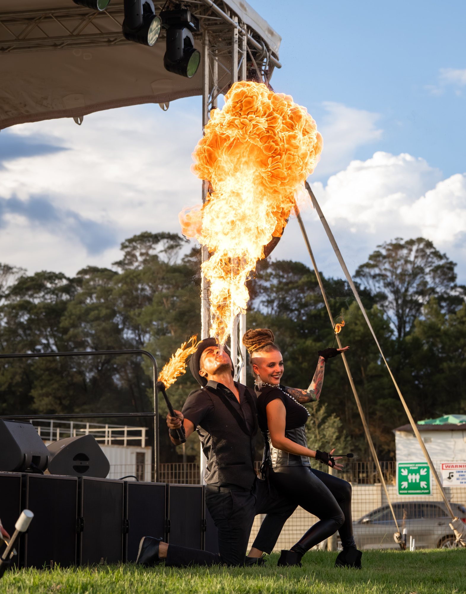 Fire performers showcasing fire breathing in an outdoor event