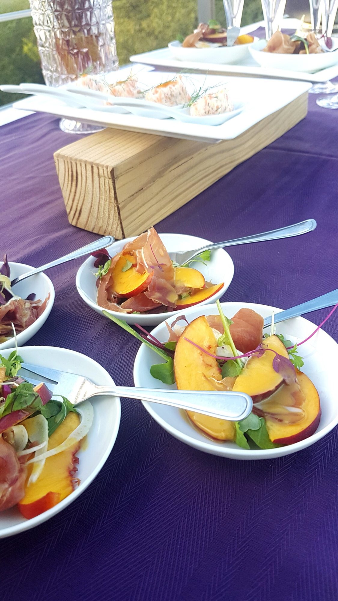 Plated seasonal salad with fruits and greens on a table