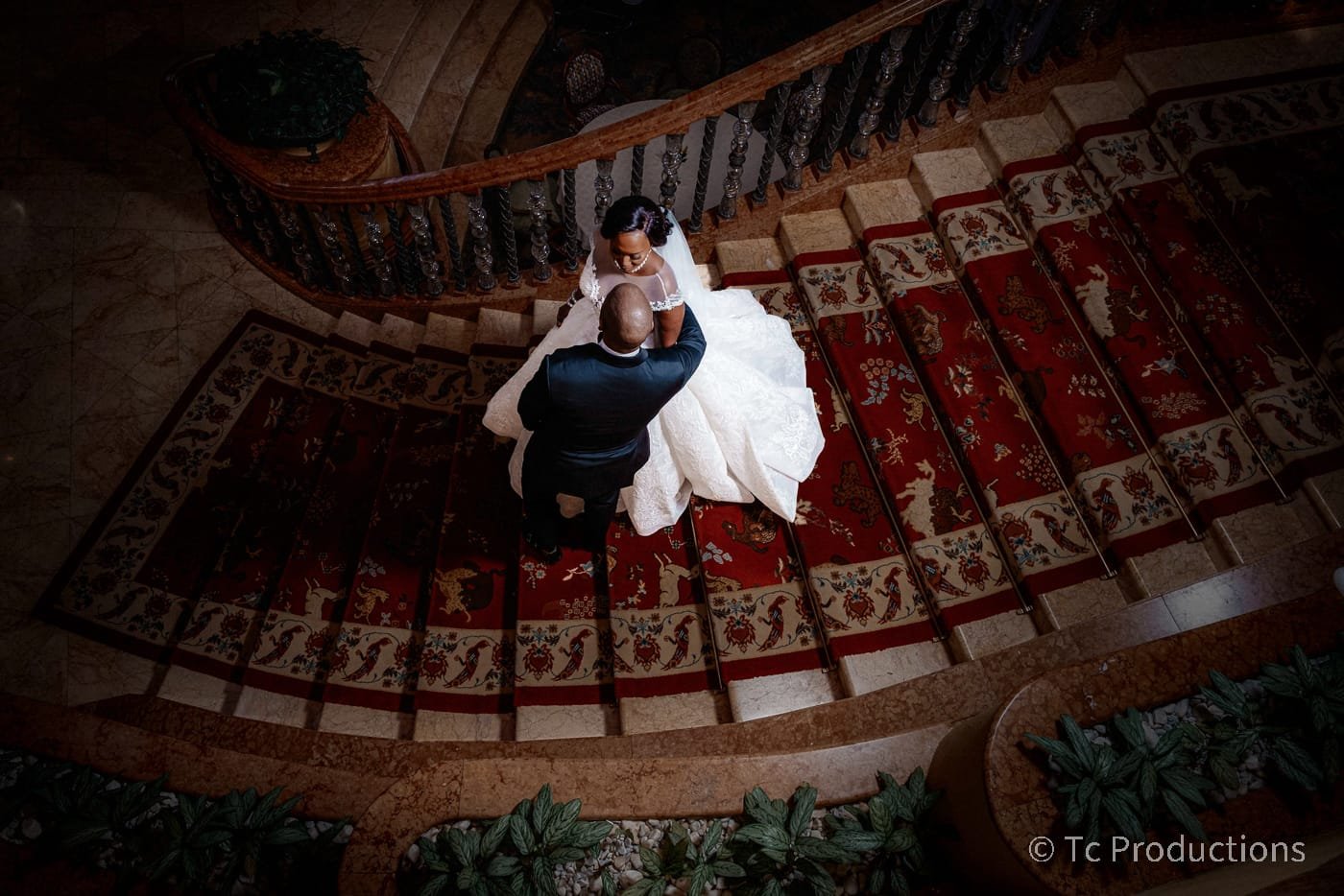 Bride and groom embracing on staircase