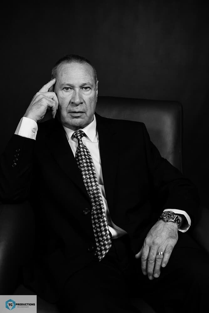 Black and white professional portrait of a man in a suit