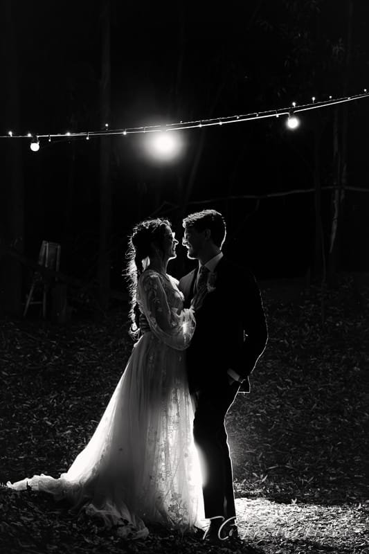 Silhouette of a couple under lights at night.