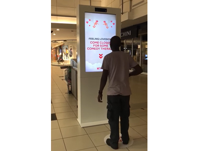 Interactive touch screen kiosk displaying engaging content