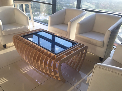 Elegant lounge seating with wooden coffee table and white chairs.
