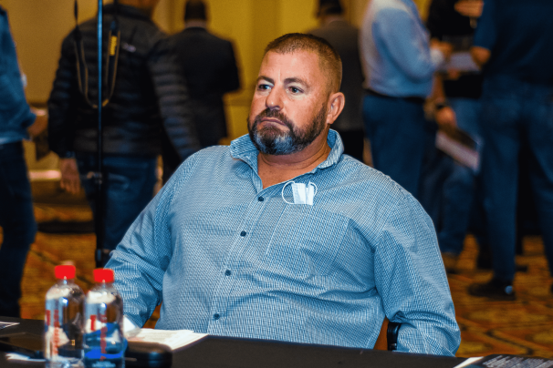 Participant seated at a conference table in a networking event.