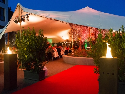 Bedouin tent setup with red carpet and torches