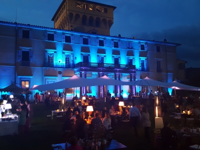 Outdoor event with stretch tents and blue lighting.