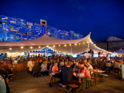 Lively outdoor gathering under a Bedouin stretch tent