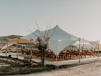 Bedouin tent with wooden tables in an outdoor setting