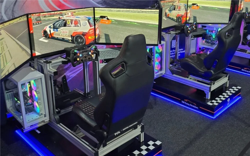 Two racing simulators with screens and gaming setups