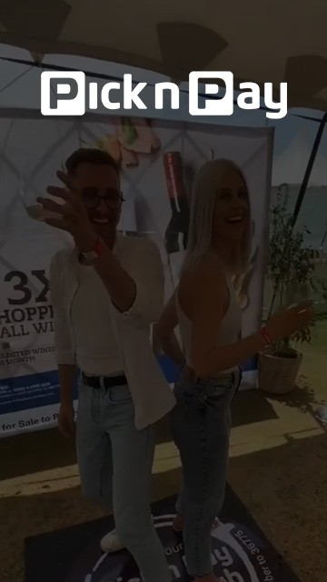Couple posing on a 360 photo booth platform