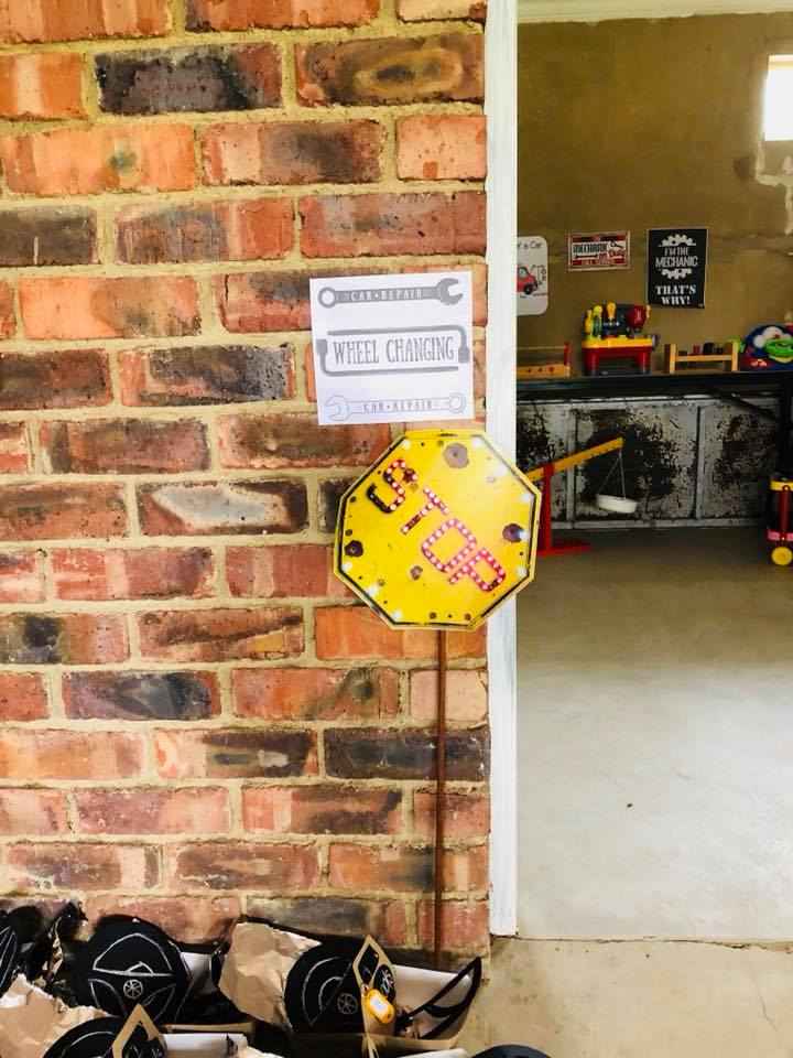 A sign indicating 'Wheel Changing' next to a 'STOP' sign.