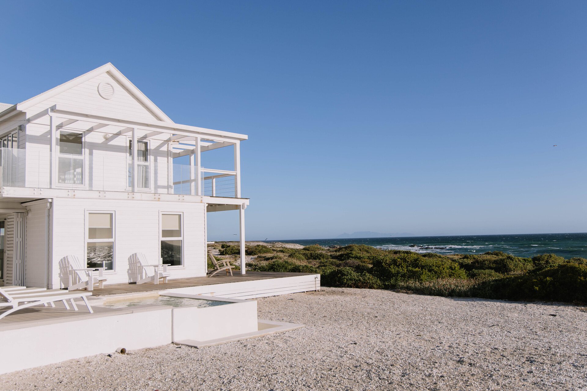 Exterior of a modern white beach house by the ocean