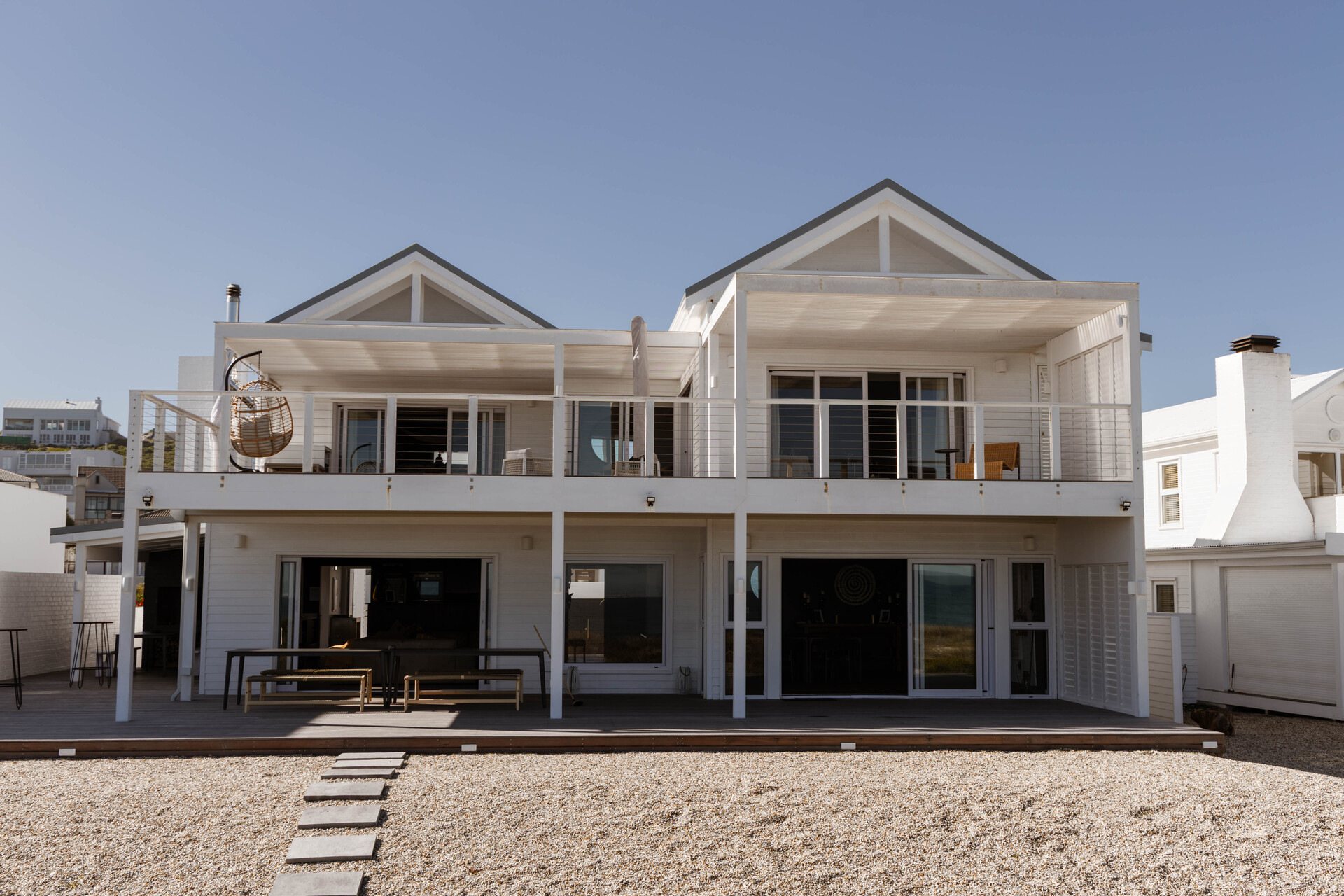 Modern beach house with wooden decks near the coast.