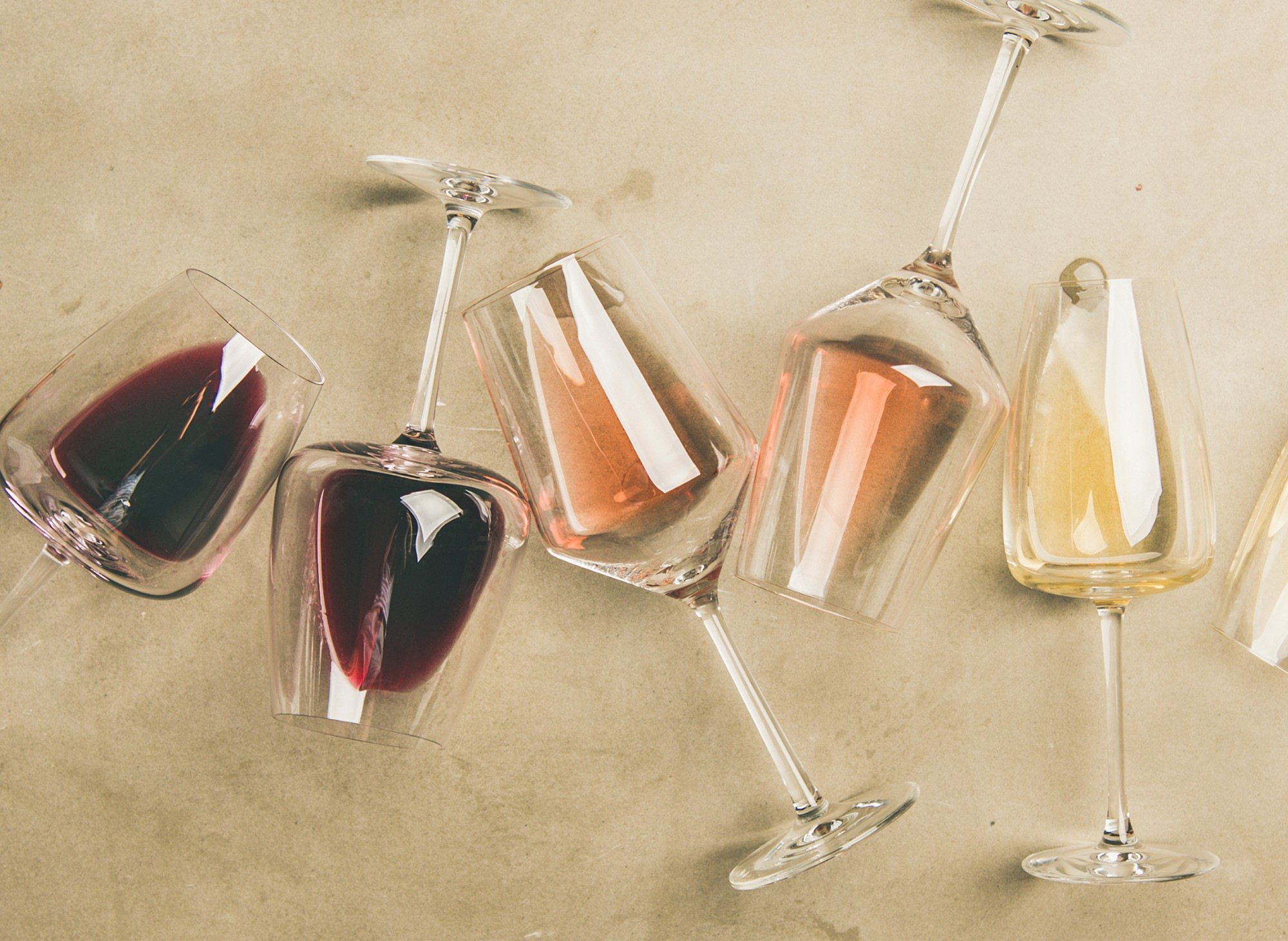 Assorted wine glasses with red, rosé, and white drinks