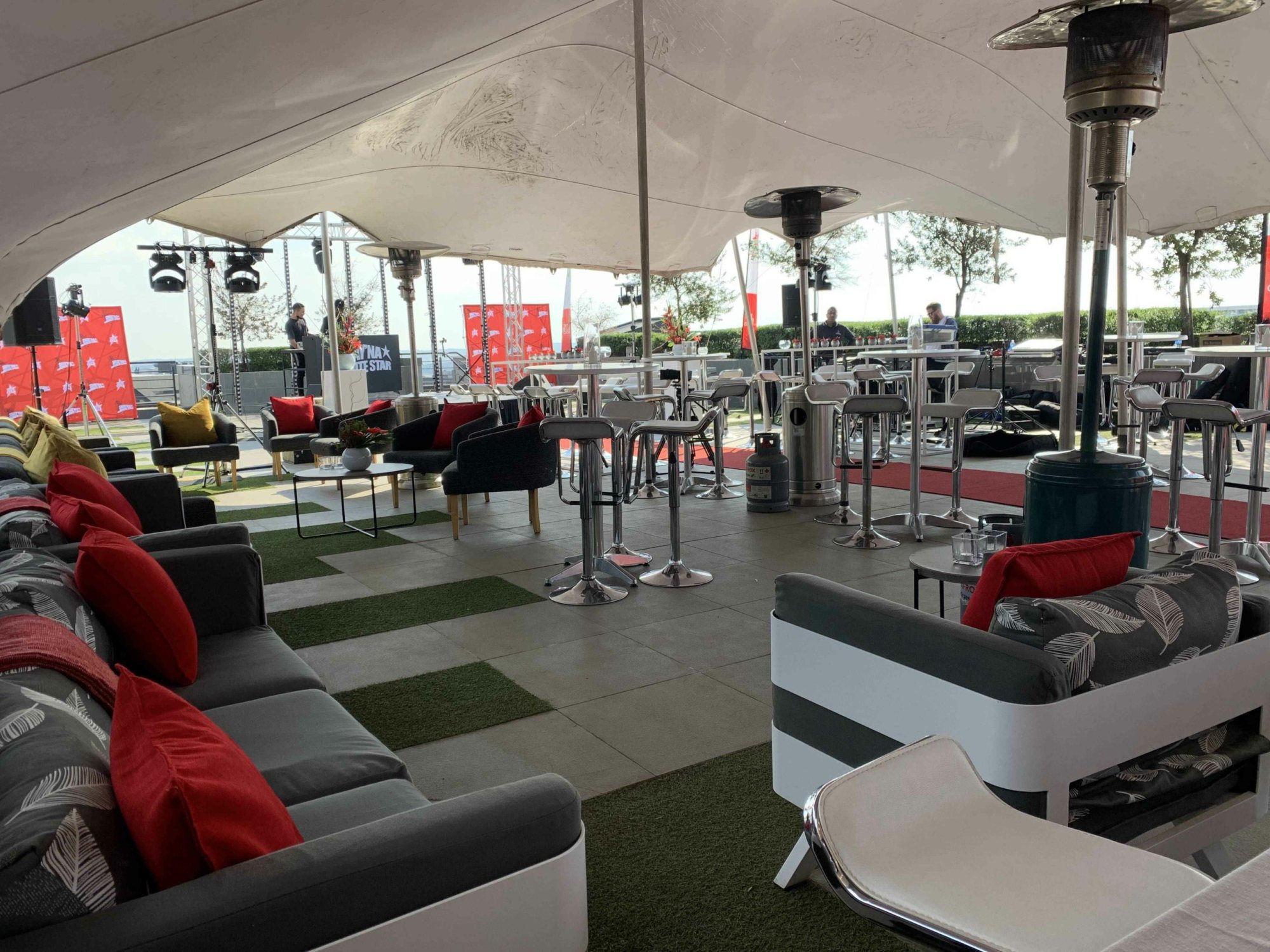 Rooftop lounge area with seating and heating lamps