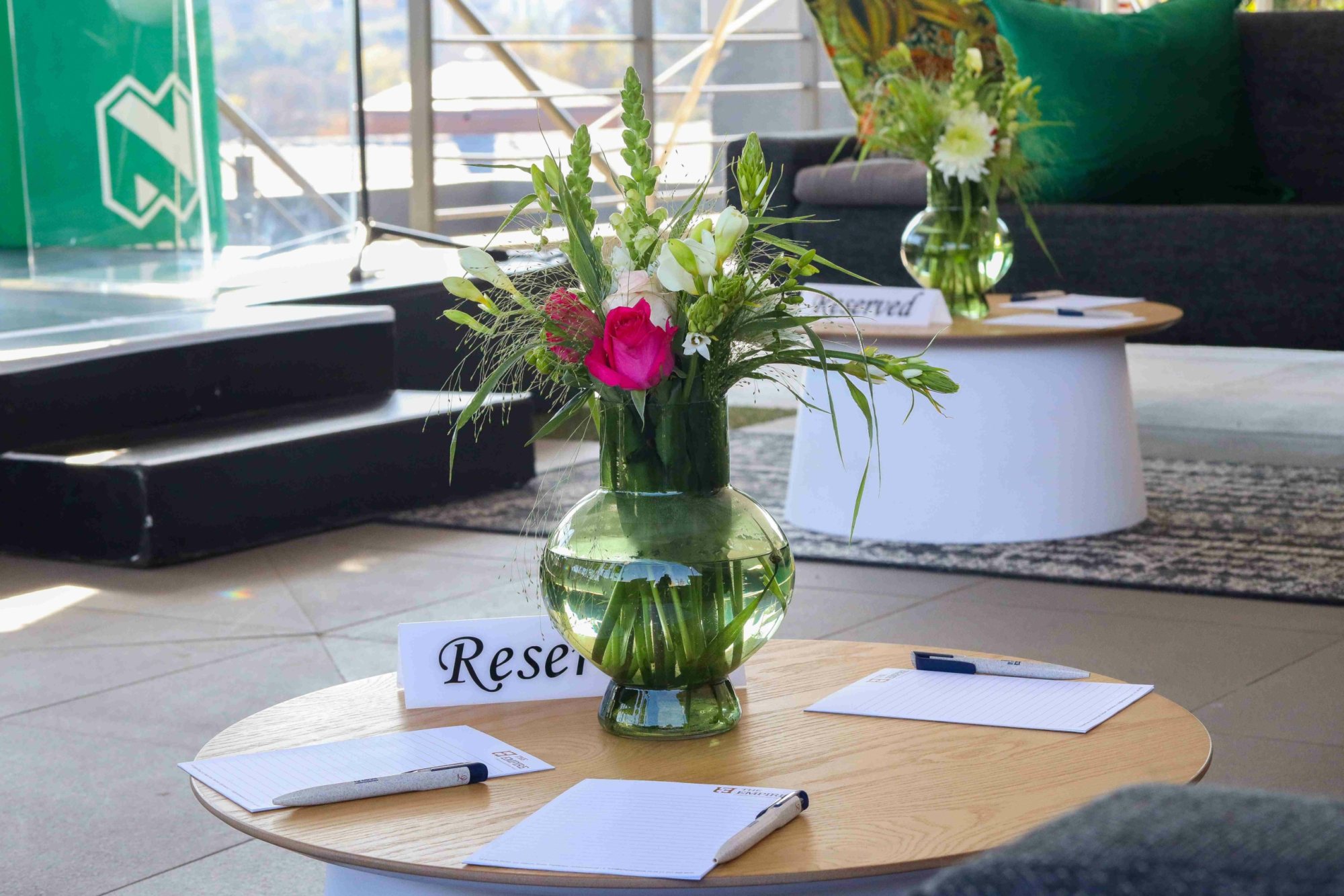 Floral centerpieces on tables with reserved signs