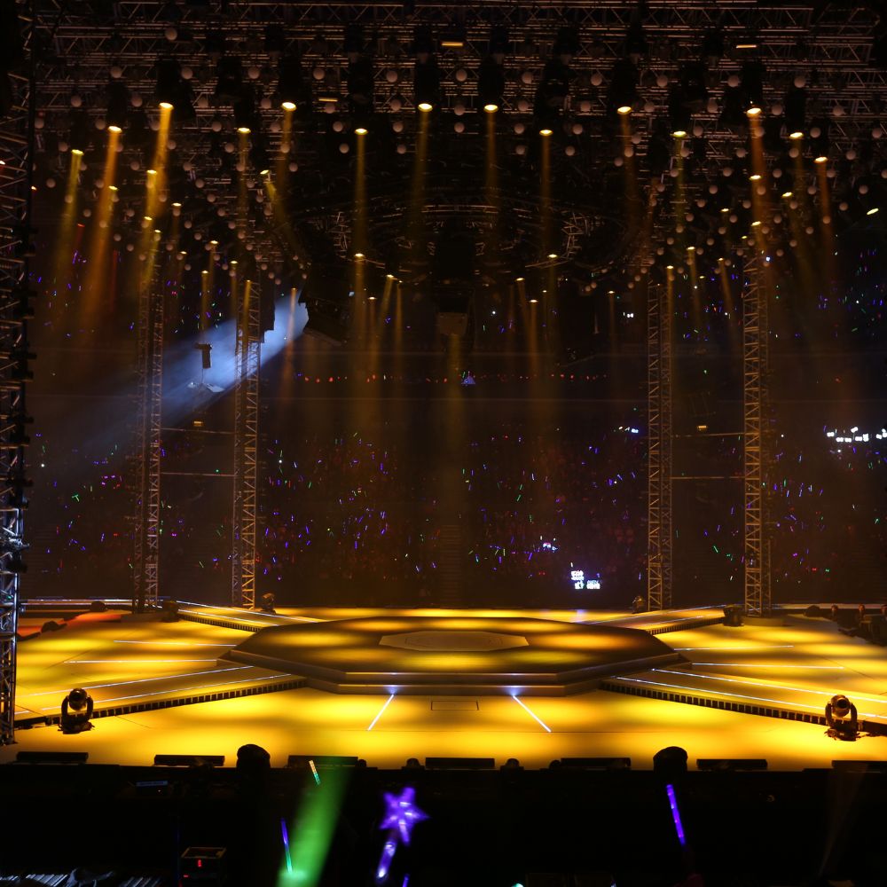 Illuminated stage setup with multiple lights and a round platform