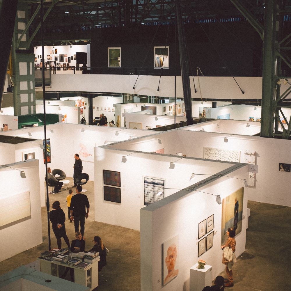 Wide view of an art gallery with various artwork on display
