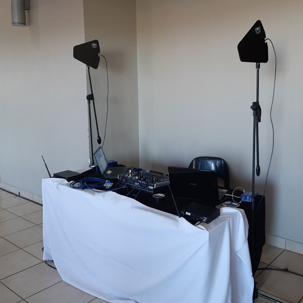 DJ setup with speakers and mixing console on a table