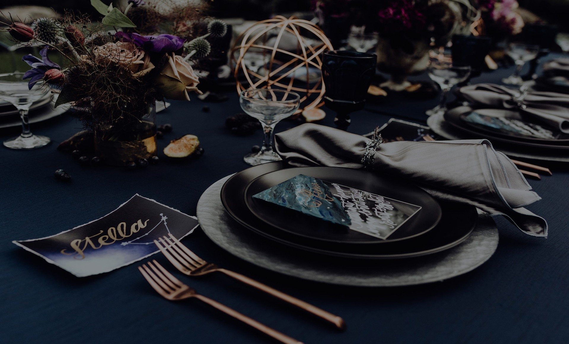 Elegant table setting with dark blue linens and decorative elements