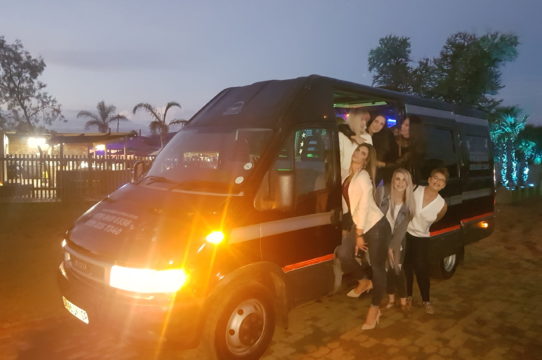 Party Bus parked with happy guests ready to celebrate