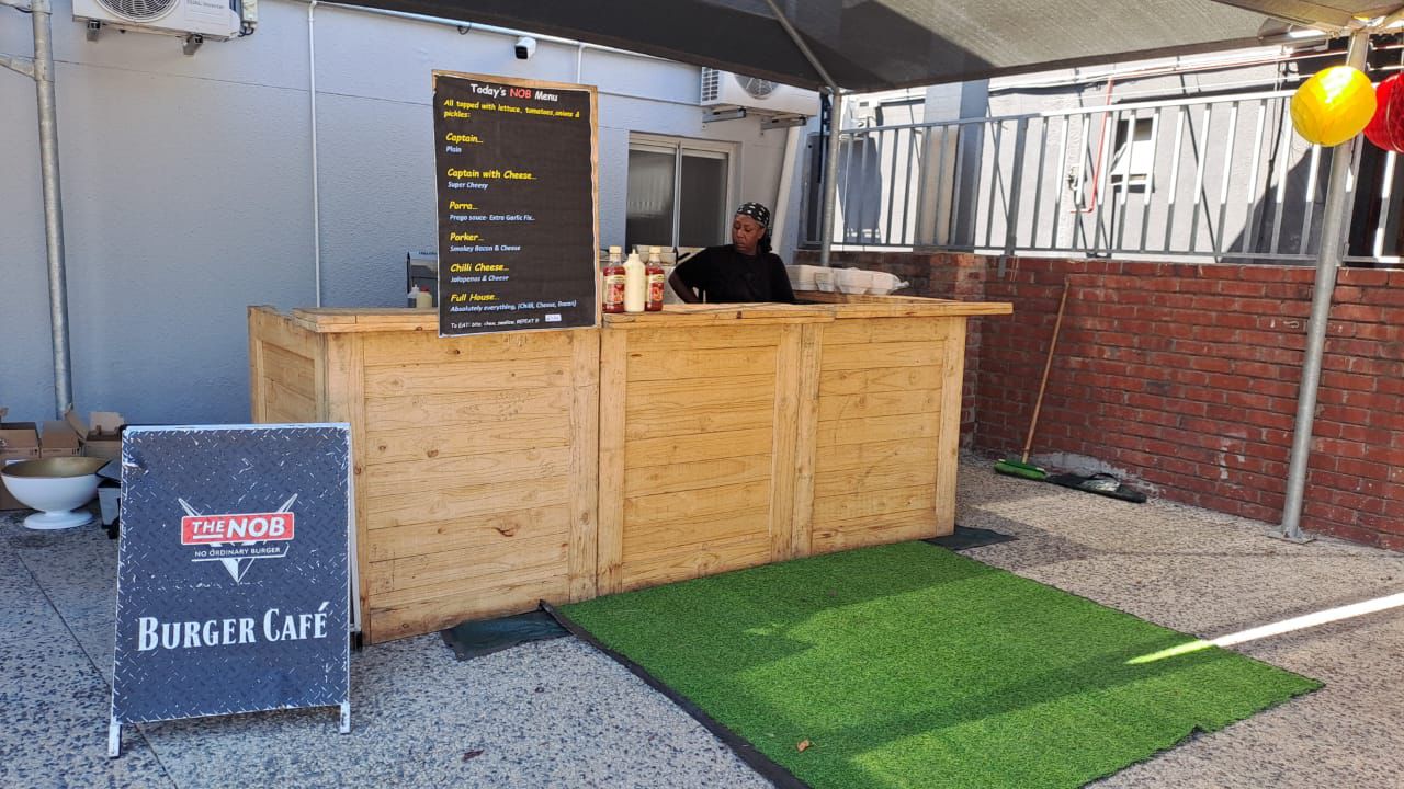 Wooden food service counter with menu and staff