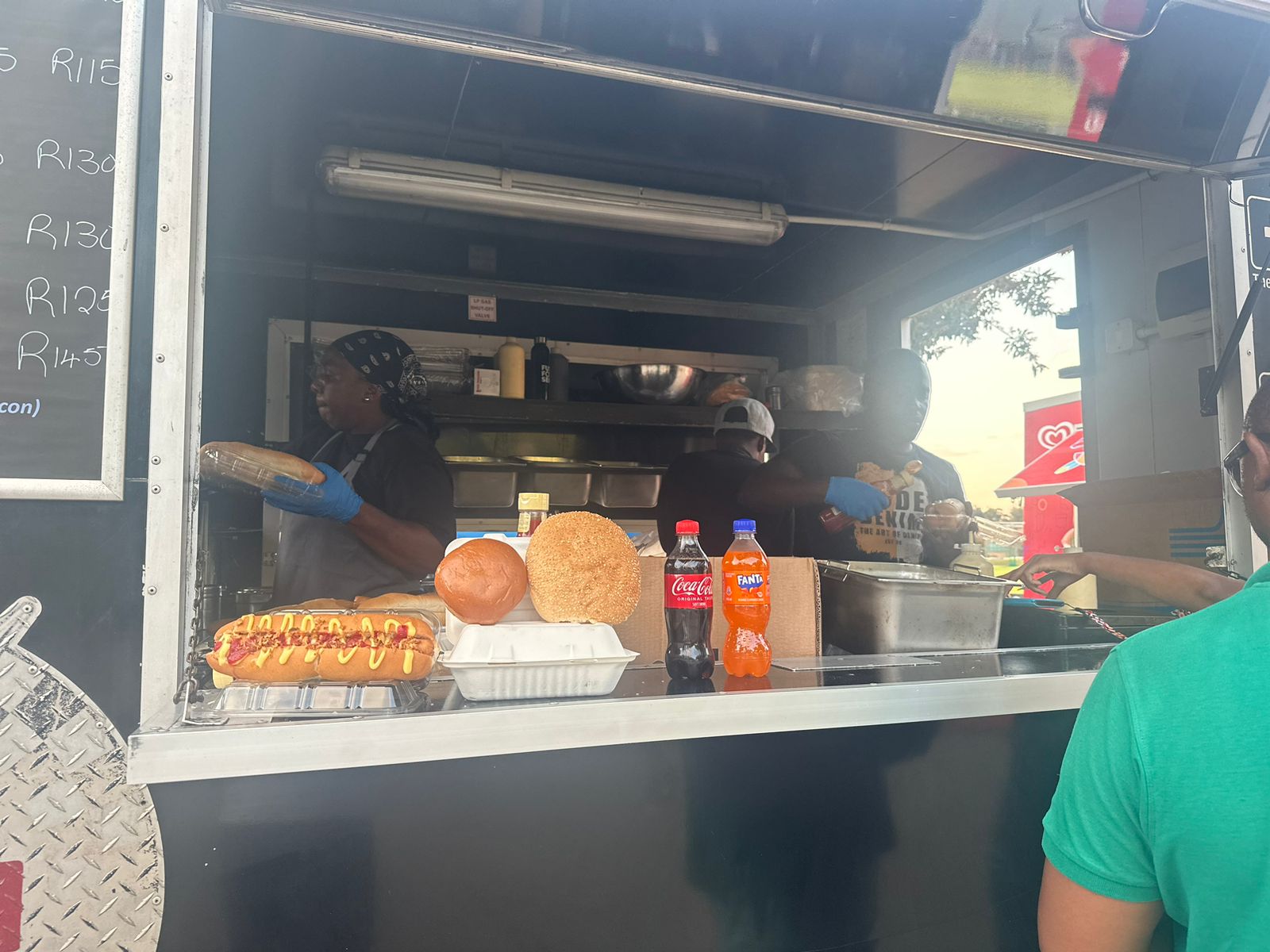 Food truck team serving burgers and hot dogs.