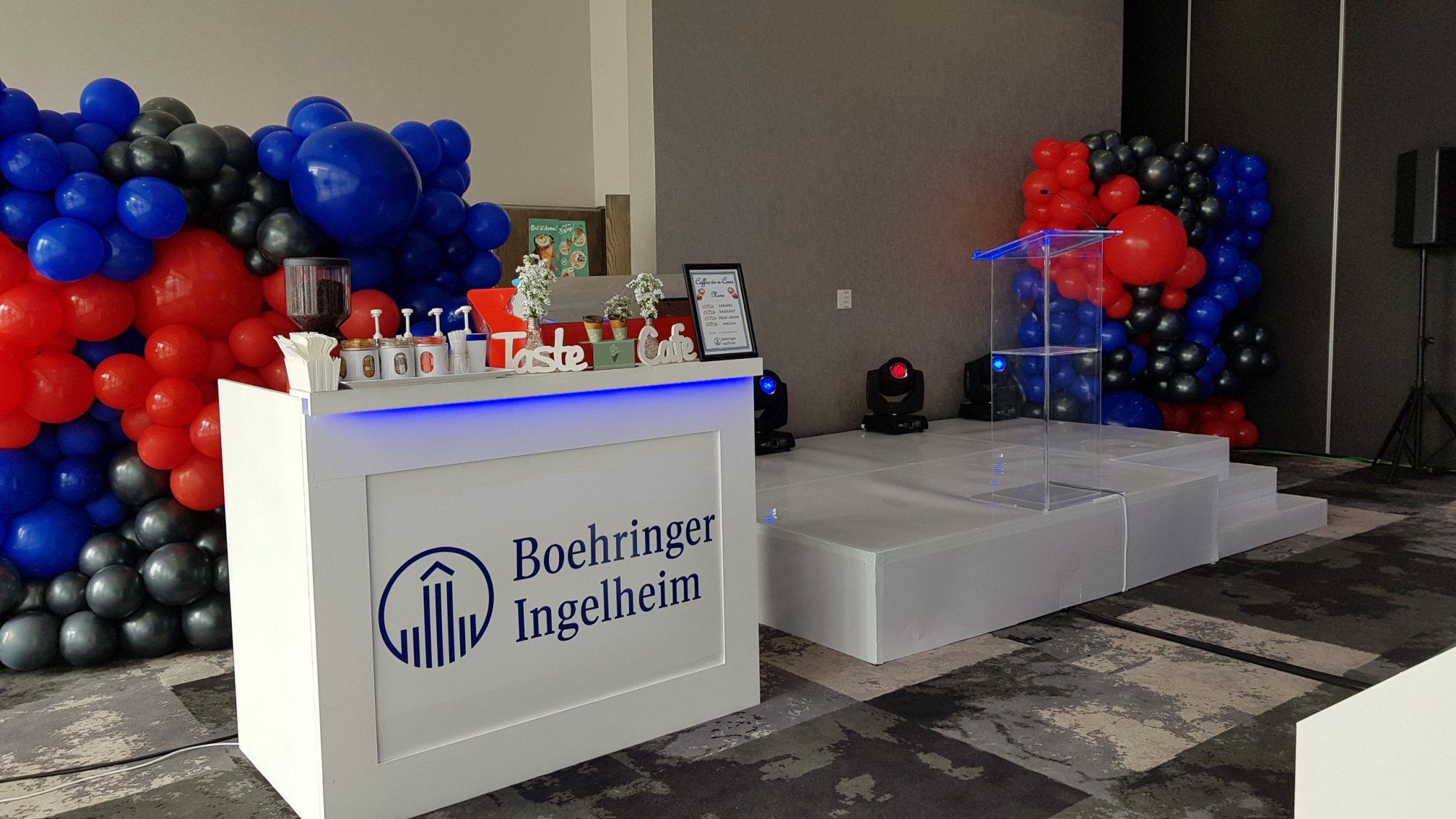 Stage setup with logo and decorative balloons