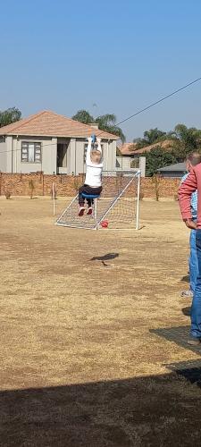 Child playing on a jungle gym in a grassy area