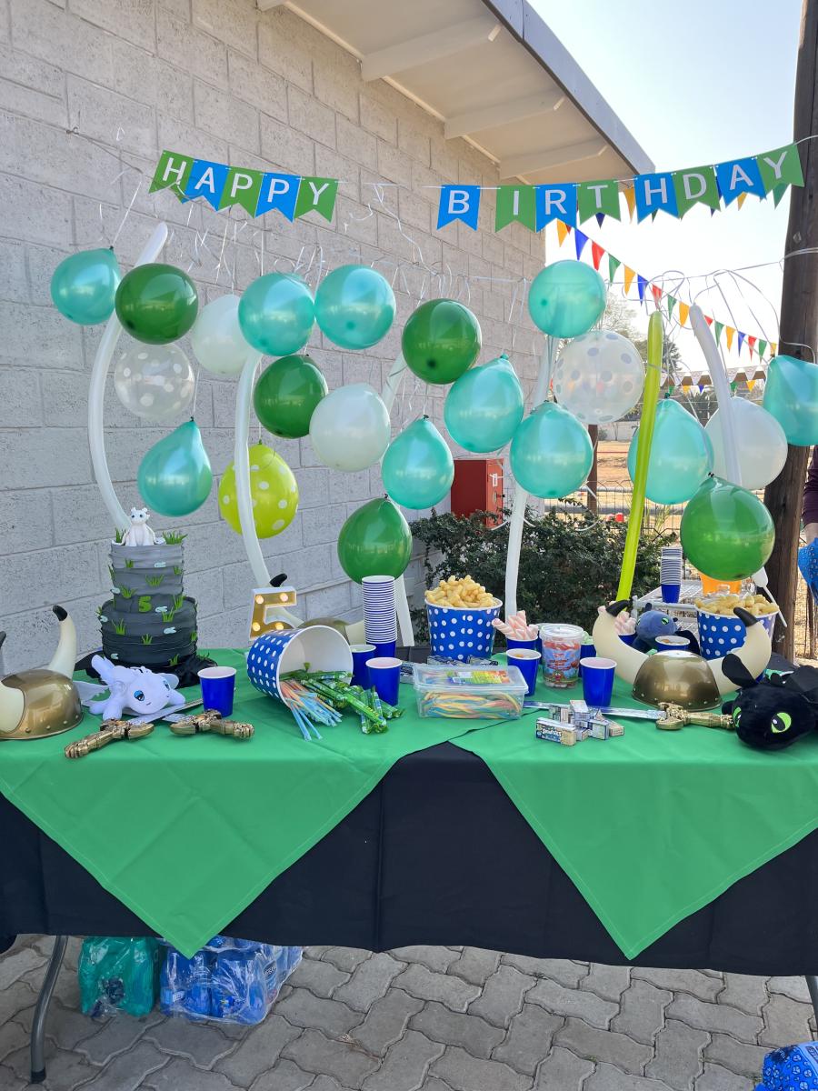 Festive birthday table with balloons, tableware, and decorations