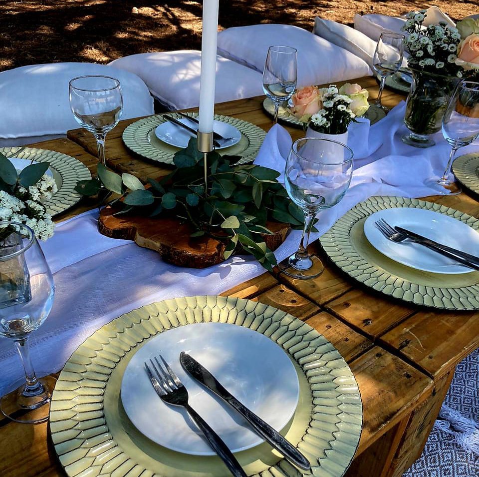 Decorated picnic table with tableware and flowers