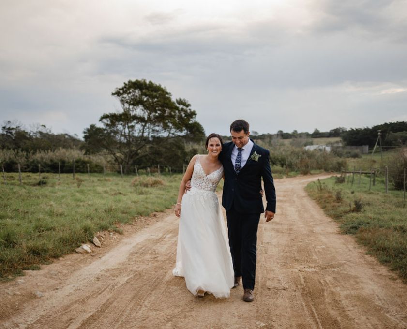 Bride and groom walking on a dirt road