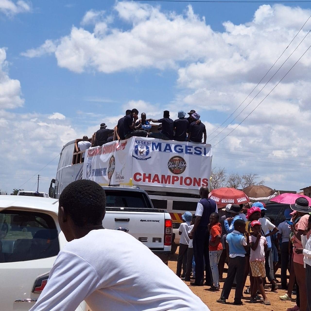 Party bus with champions banner at community event