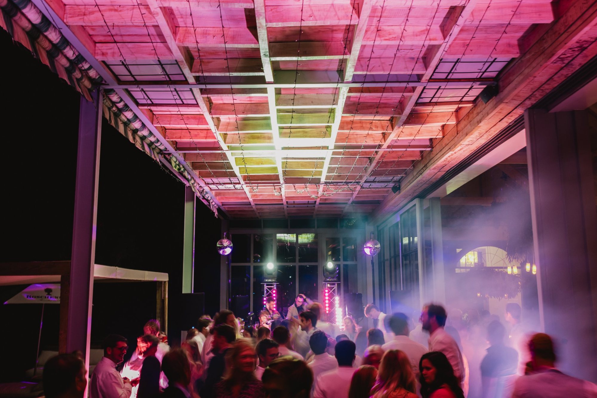 Dancefloor with vibrant lighting and guests celebrating