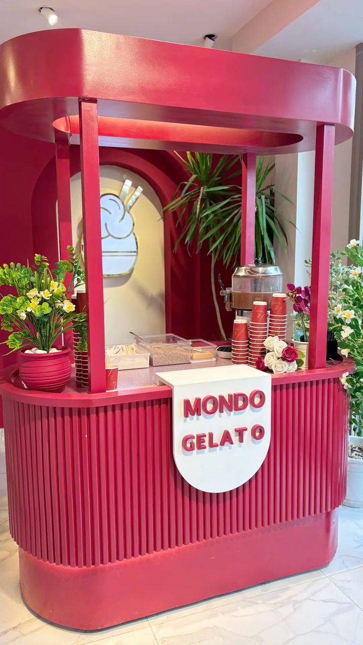 Bright red gelato stall with decorative flowers and signage
